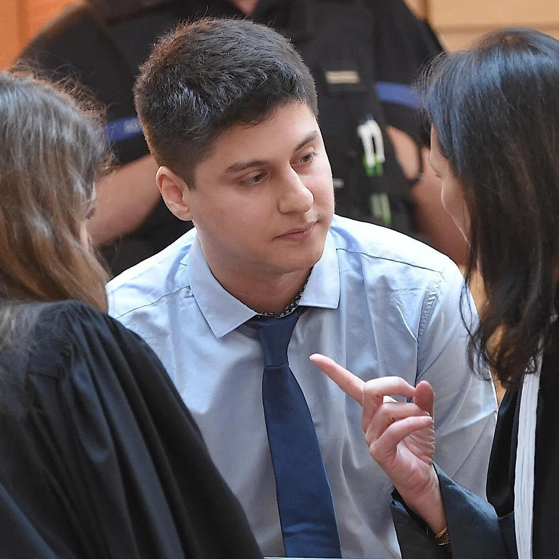 Chilean defendant Nicolas Zepeda (centre) speaking with his lawyers, on the first day of his 2022 trial.