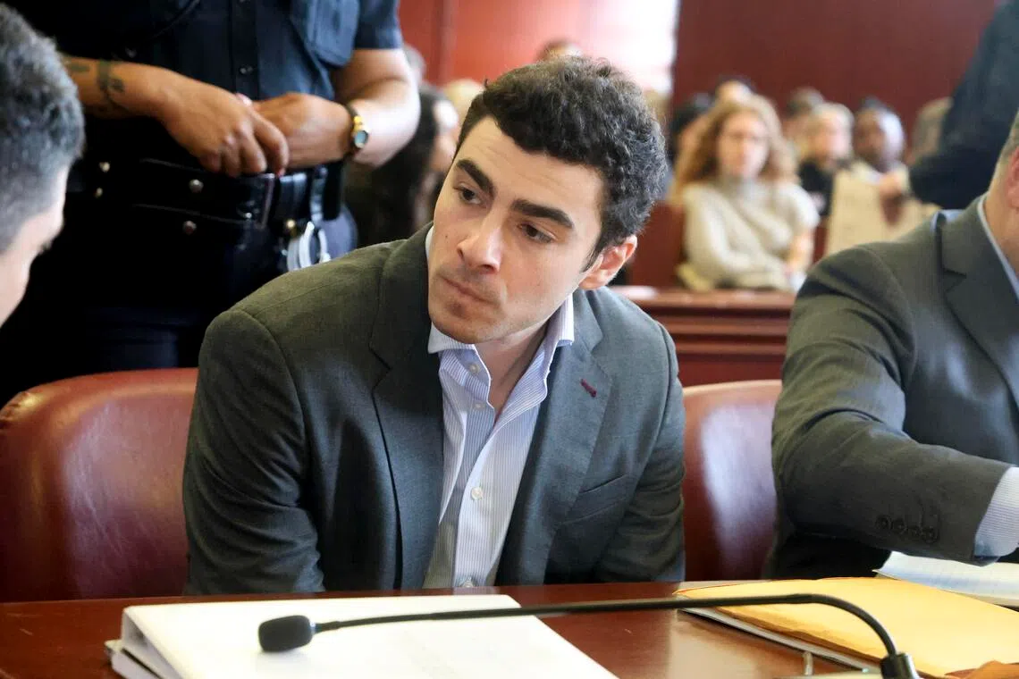Luigi Mangione - charged in the murder of UnitedHealthcare chief executive Brian Thompson, confers with one of his attorneys at a pretrial hearing in Manhattan on Dec 11.