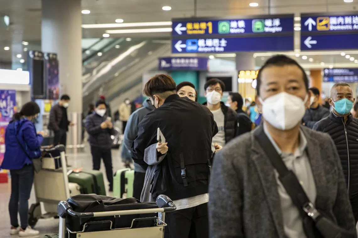 A couple embrace in the arrival hall at Pudong International Airport in Shanghai, China, on Sunday, Jan. 8, 2023. The reopening of China’s borders marks the end of Covid Zero, a strategy that left the world’s second-biggest economy isolated for three years and weighed heavily on the economy.