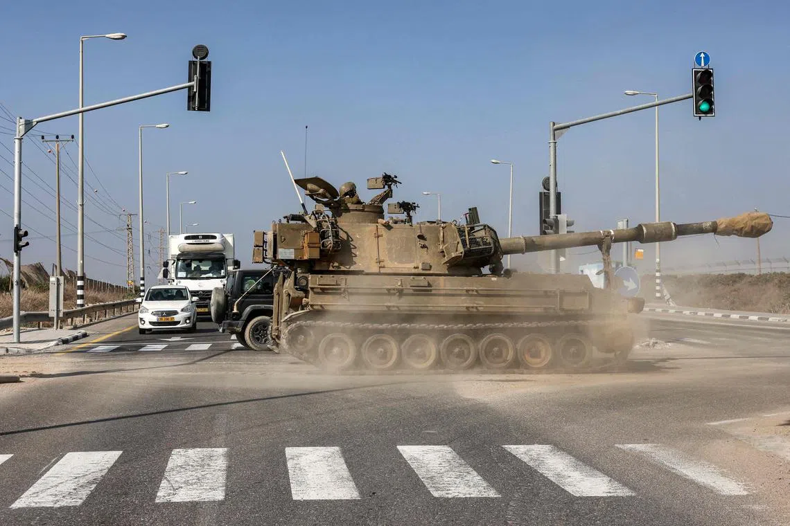 The Israeli army's self-propelled artillery howitzer crossing a road along the border with the Gaza Strip on Nov 1.