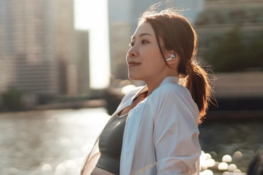Woman listening to music on noise-cancelling earbuds