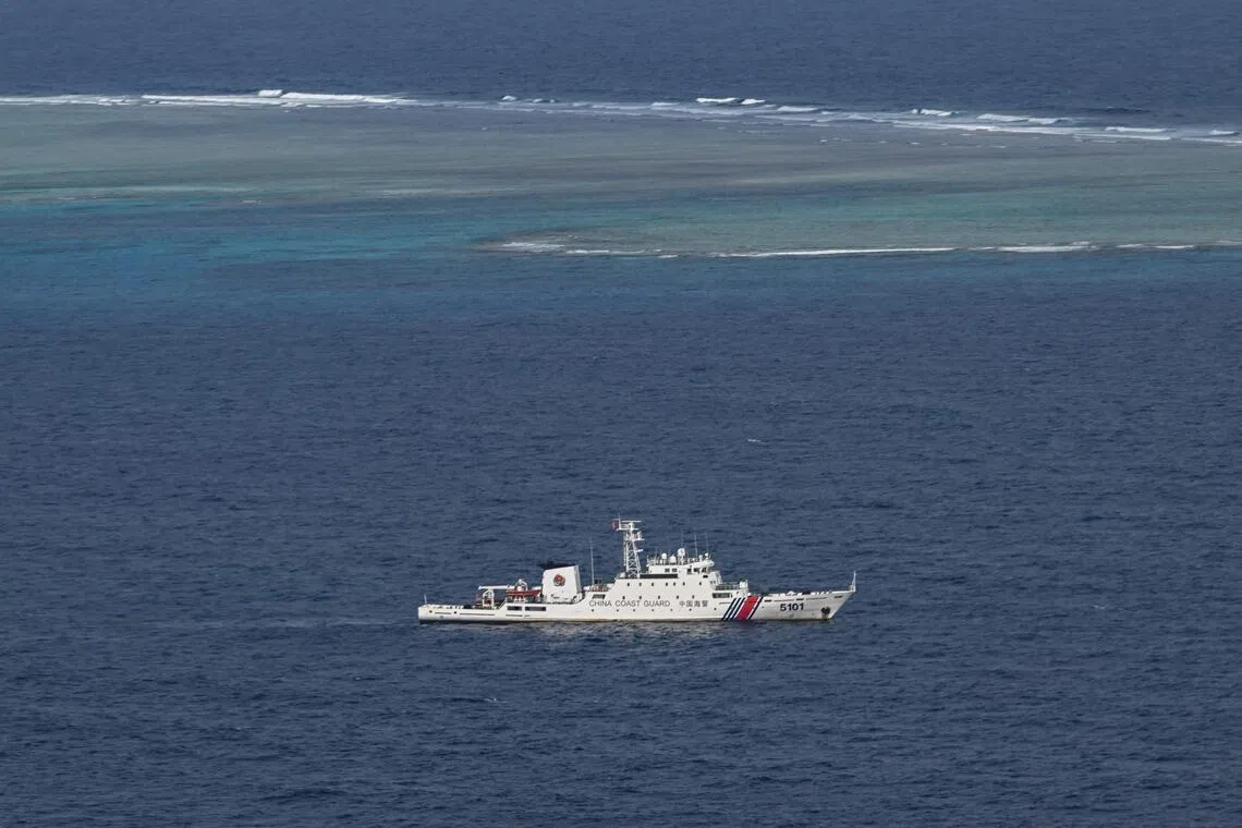 A China Coast Guard vessel patrols in waters around the Philippine-held Thitu island in the South China Sea.
