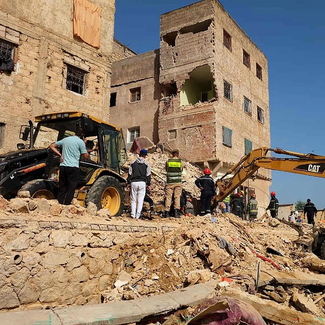 Rescuers search through the rubble of a four-storey building that collapsed overnight in the Moroccan city of Fes, on May 21.