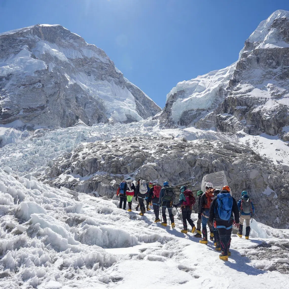 Members of an expedition team hike at Khumbu Icefall on April 22, 2026.