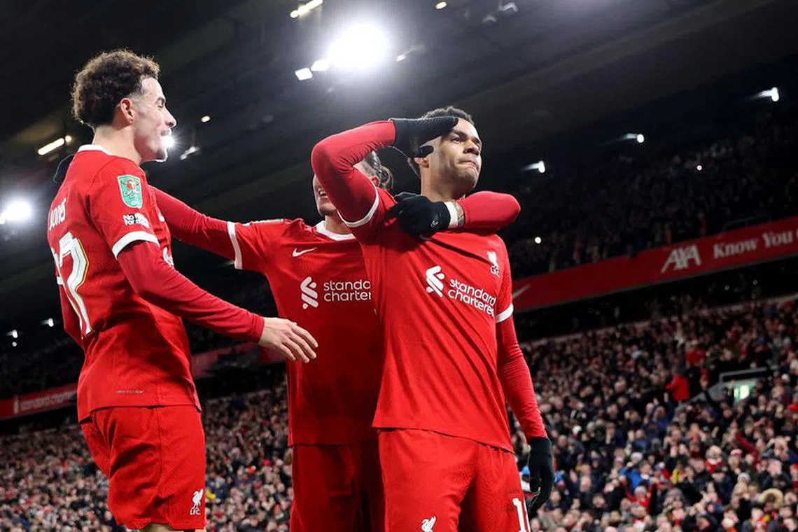 Soccer Football - Carabao Cup - Semi-Final - First Leg - Liverpool v Fulham - Anfield, Liverpool, Britain - January 10, 2024 Liverpool's Cody Gakpo celebrates scoring their second goal with Curtis Jones and Darwin Nunez REUTERS/Carl Recine