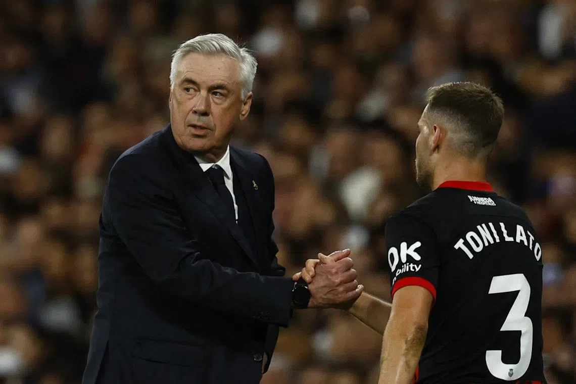 Soccer Football - LaLiga - Real Madrid v RCD Mallorca - Santiago Bernabeu, Madrid, Spain - May 14, 2025 Real Madrid coach Carlo Ancelotti shakes hands with RCD Mallorca's Toni Lato REUTERS/Susana Vera