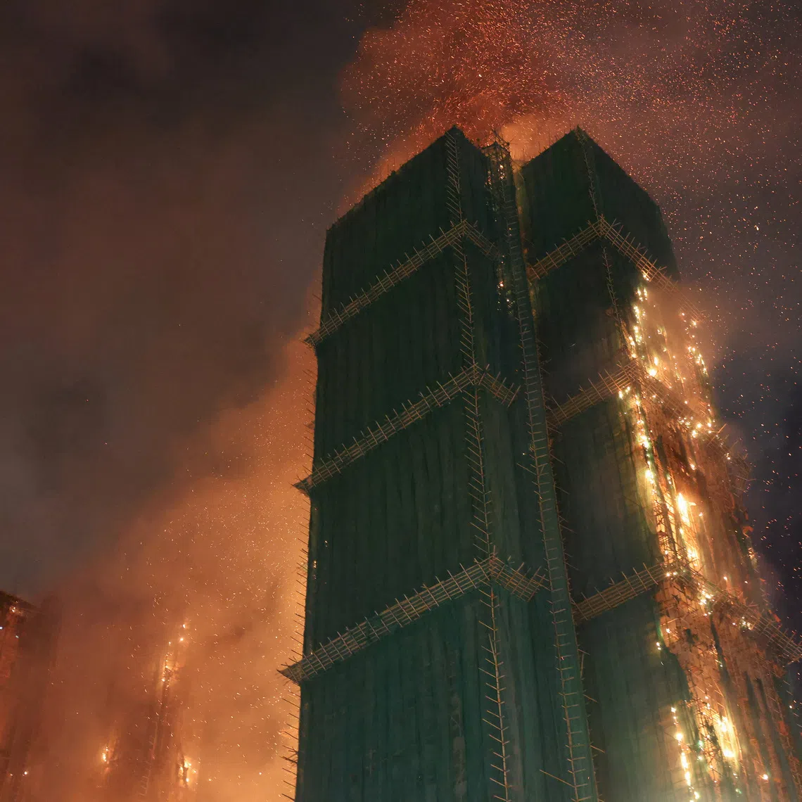 Fire burns bamboo scaffolding across multiple buildings at Wang Fuk Court housing estate, in Tai Po, Hong Kong, China, November 26, 2025. REUTERS/Tyrone Siu