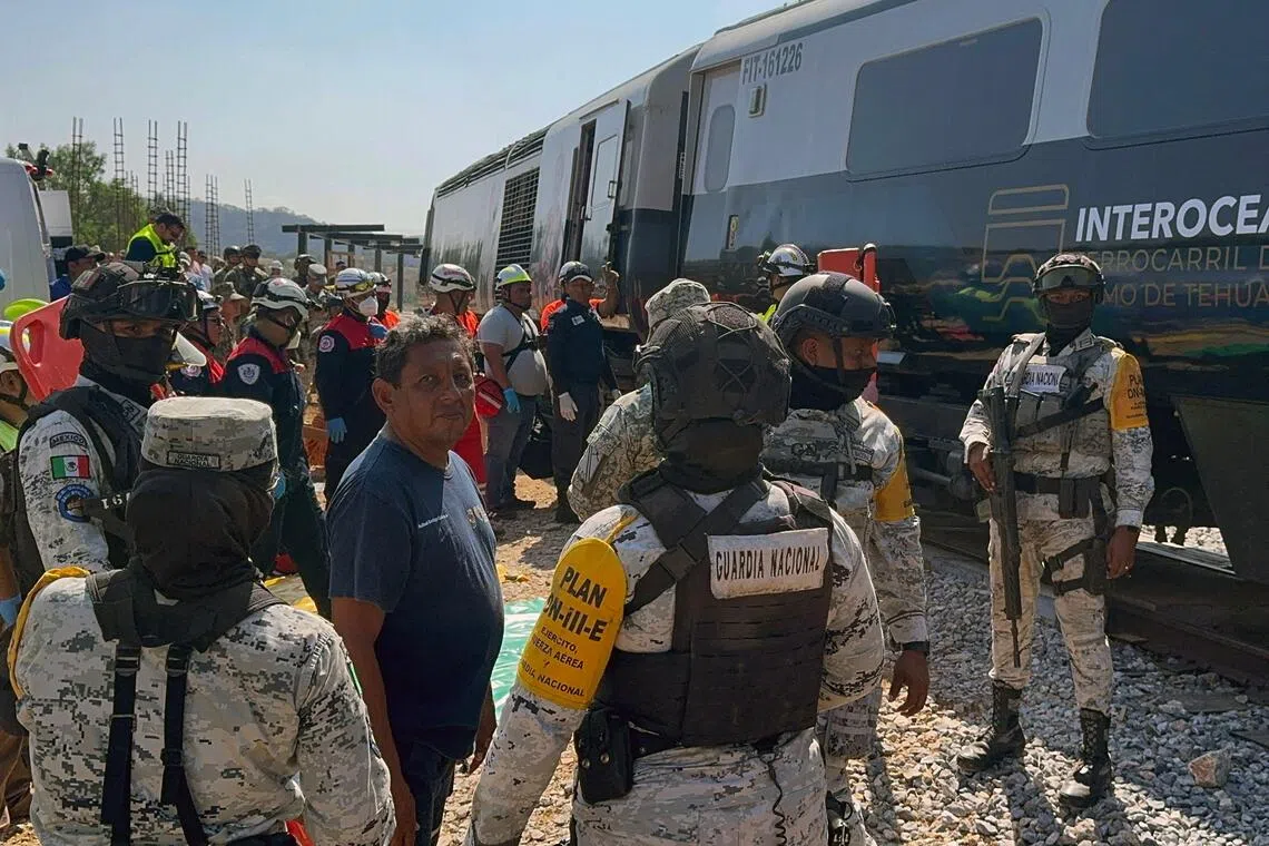 Mexican Army soldiers and Civil Protection members rescue passengers from the Interoceanic train that derailed in the Asuncion Ixtaltepec area on the route to Oaxaca, Mexico, on Dec 28, 2025.