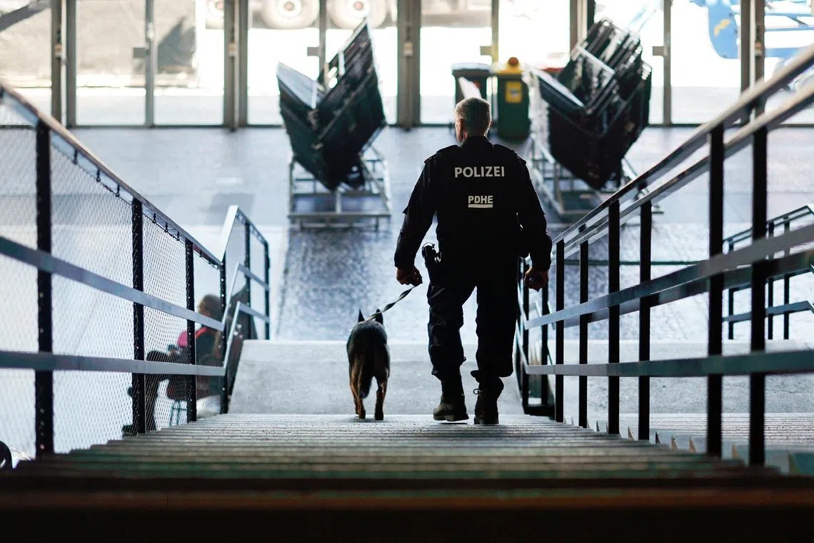 A police officer walks with a K9 unit as police present security measures ahead of the Eurovision Song Contest in Vienna, Austria, April 29, 2026. REUTERS/Lisa Leutner