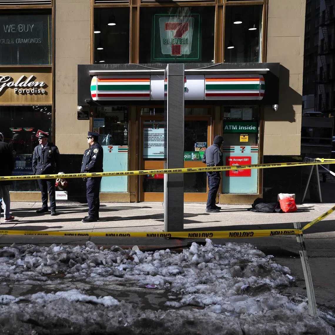 Police tape blocks off the sidewalk outside a 7-Eleven in Midtown Manhattan where the police said a man was fatally shot on Feb 12.