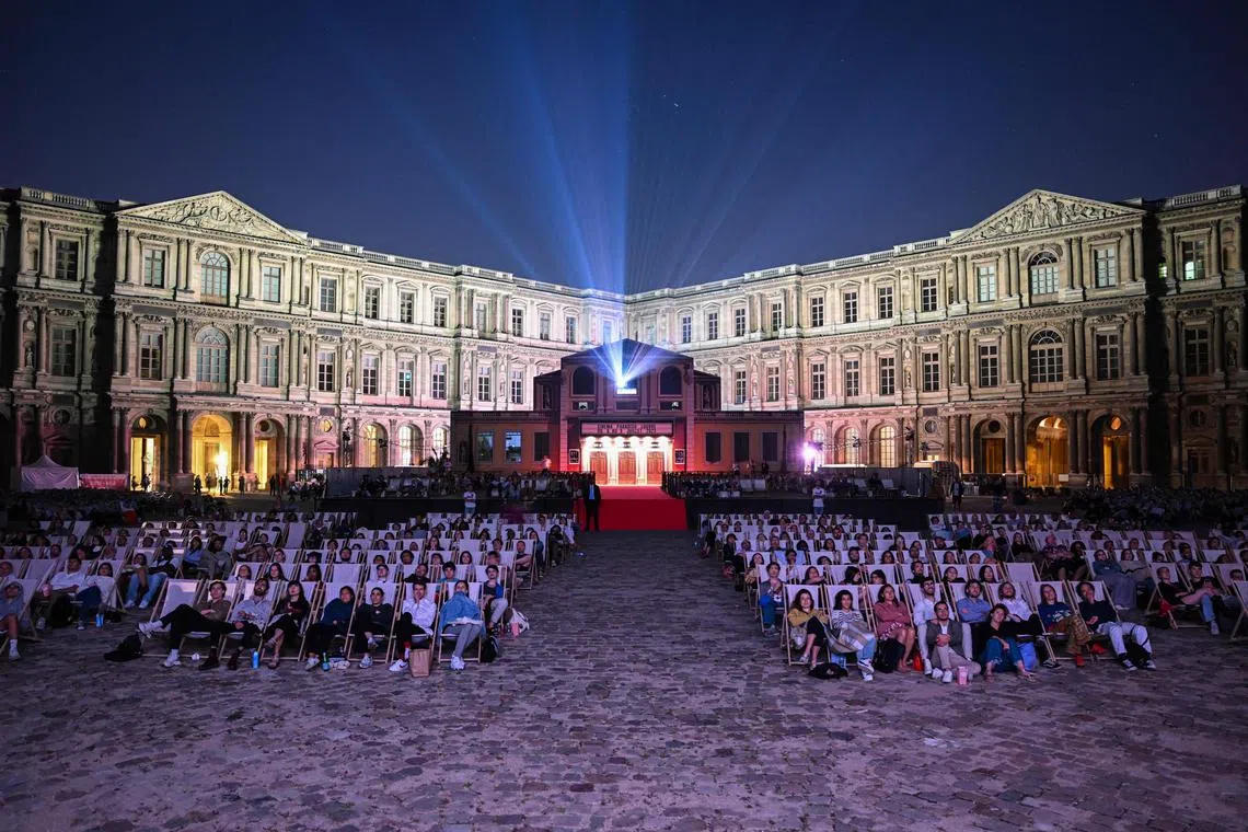 Guests attend a screening of the film "Goodfellas" on the opening day of the openair cinema festival (Cinema Paradisio - festival de cinema en plein air) at The Louvre Museum in Paris on July 6.