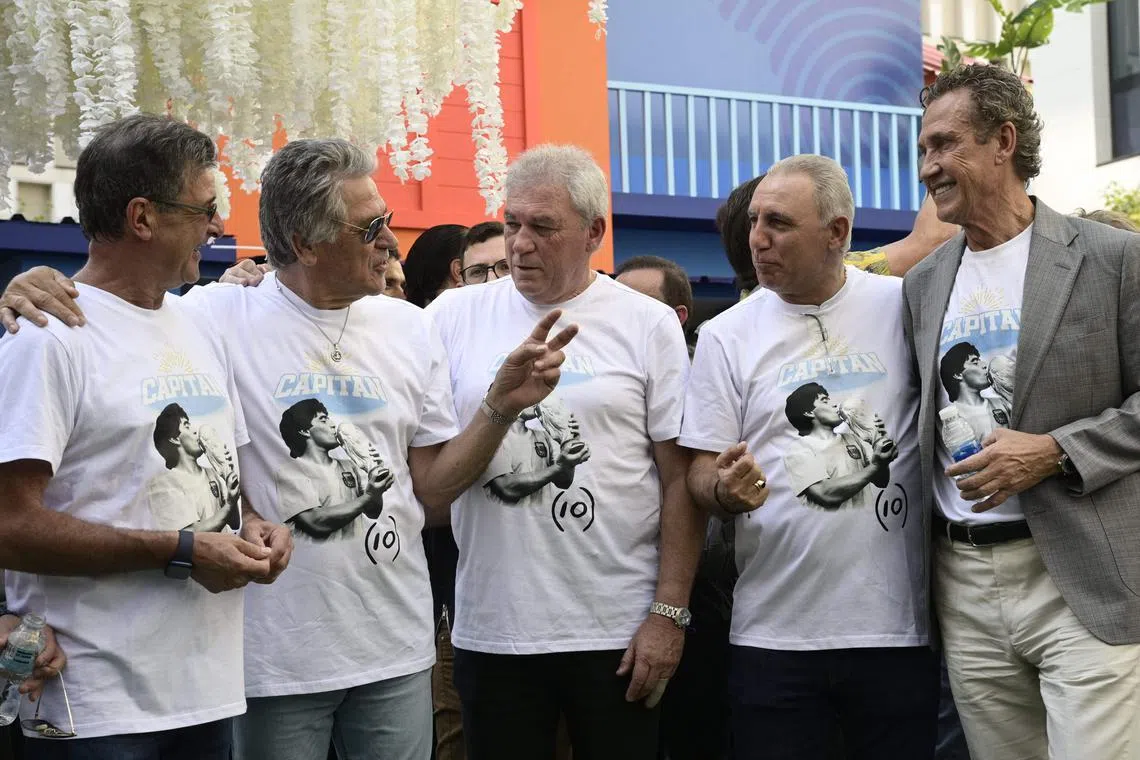 Bulgarian former football star Hristo Stoichkov (second from right) and Argentinian former World Cup winners (left to right) Mario Kempes, Ubaldo Fillol, Nery Pumpido and Jorge Valdano chat during a tribute ceremony to late football star Diego Maradona on the 2nd anniversary of his death at the Conmebol fan zone on Friday.