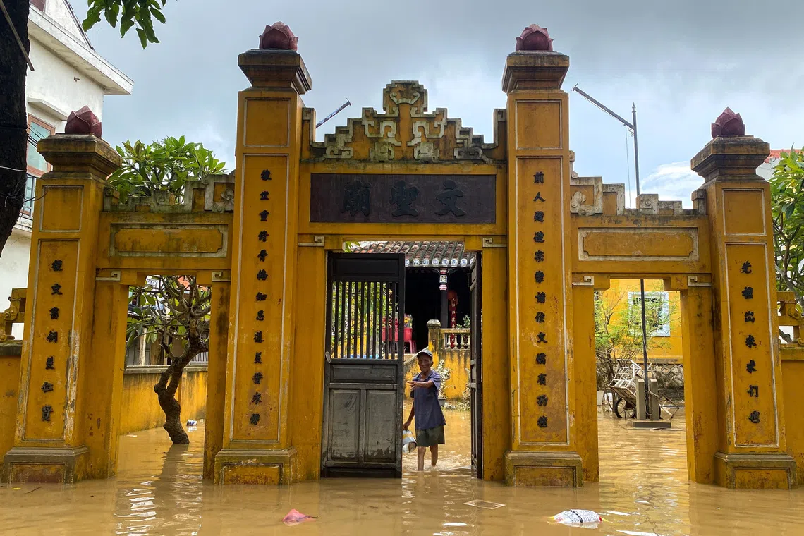A man wades through a flooded area in Hoi An, following deadly floods in central Vietnam, October 31, 2025. REUTERS/Thinh Nguyen
