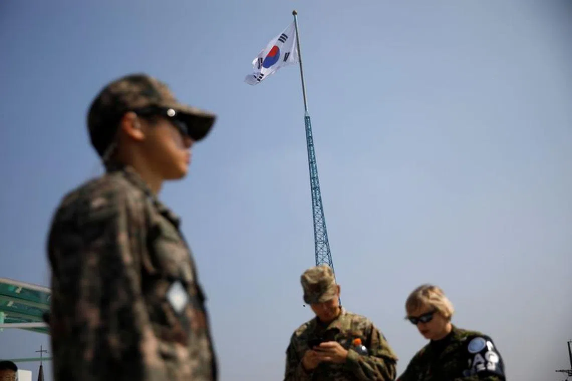 A South Korean flag flutters on the top of a 100-metre tower as soldiers stand guard at the Tae Sung freedom village near the Military Demarcation Line (MDL), inside the demilitarised zone separating the two Koreas, in Paju, South Korea, September 30, 2019. REUTERS/Kim Hong-Ji/File photo