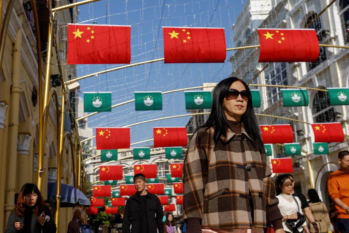 Macau and Chinese flags hang at the Senado Square, in Macau, China December 17, 2024. REUTERS/Tyrone Siu