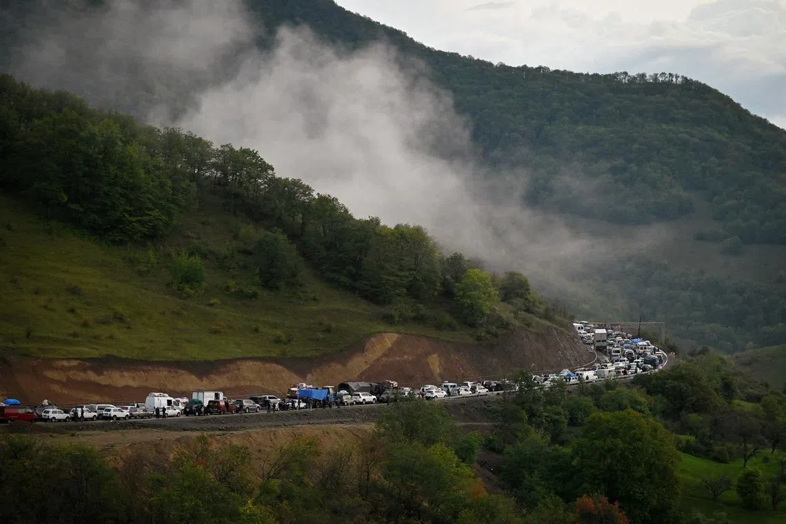 FILE PHOTO: Vehicles carrying refugees from Nagorno-Karabakh, a region inhabited by ethnic Armenians, queue on the road leading towards the Armenian border, in Nagorno-Karabakh, September 25, 2023. REUTERS/David Ghahramanyan/File Photo
