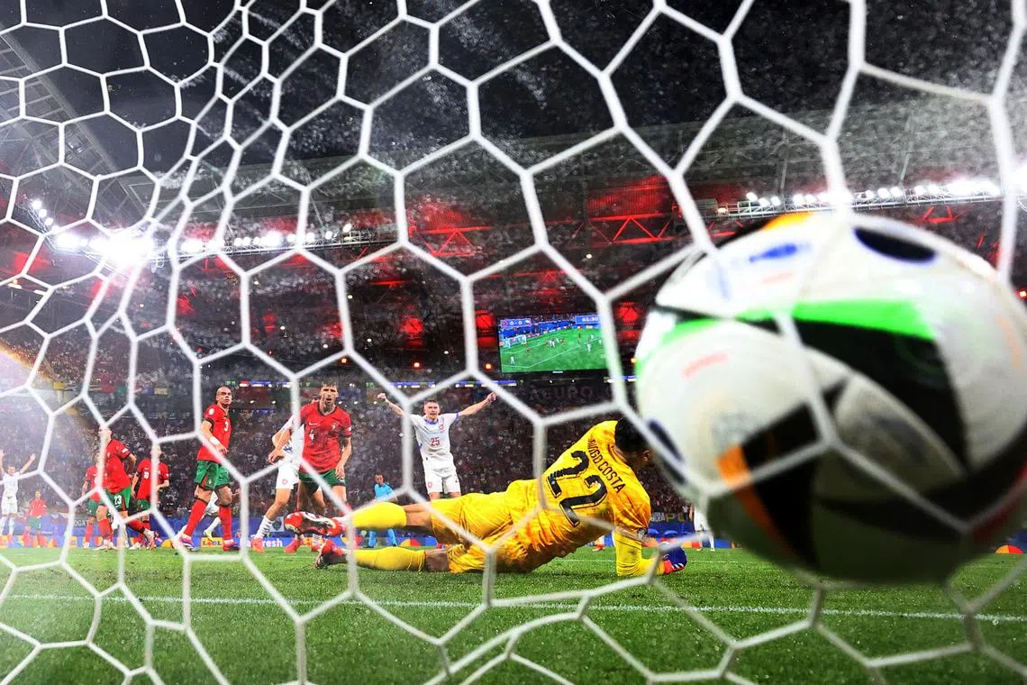 Czech Republic's Lukas Provod scores their first goal past Portugal's Diogo Costa during the UEFA Euro 2024 Group F football match between Portugal and the Czech Republic, at the Leipzig Stadium in Leipzig, on June 18, 2024.