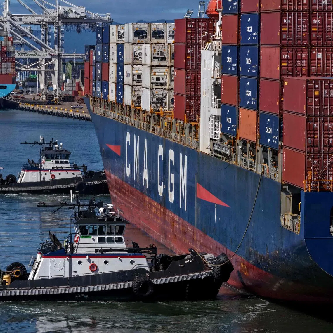OAKLAND, CALIFORNIA - OCTOBER 10: In an aerial view, tugboats assist a container ship as it arrives at the Port of Oakland on October 10, 2025 in Oakland, California. U.S. President Donald Trump is threatening to impose a massive increase of tariffs on Chinese imports in response to China's announcement of new export controls on rare earths. China controls an estimated 70% of the global supply of rare earths minerals.   Justin Sullivan/Getty Images/AFP (Photo by JUSTIN SULLIVAN / GETTY IMAGES NORTH AMERICA / Getty Images via AFP)