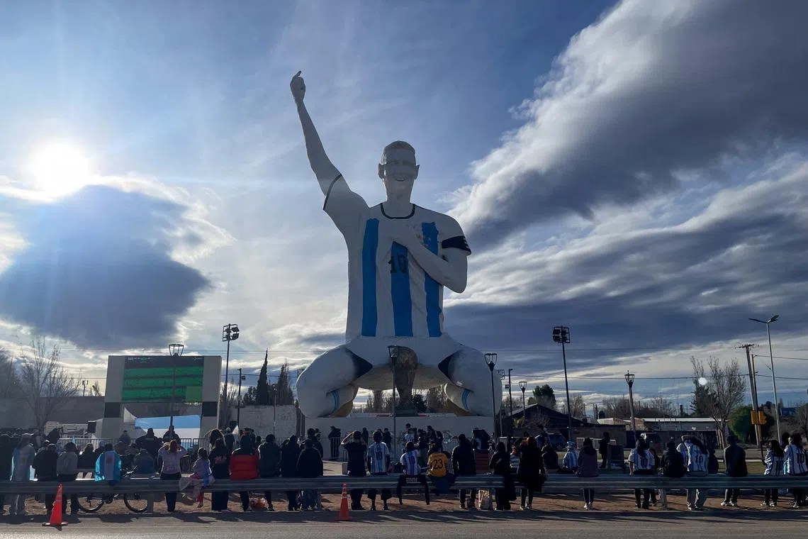People gather by a statue of Argentina's revered Lionel Messi while watching the World Cup semi-final between Argentina and England, in Cutral Co, in the Patagonian province of Neuquen, Argentina, July 15, 2026. REUTERS/Leila Miller