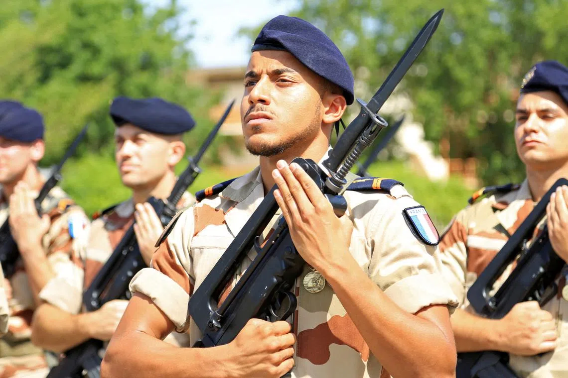 FILE PHOTO: French soldiers stand at attention during a morning drill at the French military base in Chadian capital N'Djamena, October 26, 2014. Picture taken October 26, 2014 REUTERS/Emma Farge/File Photo
