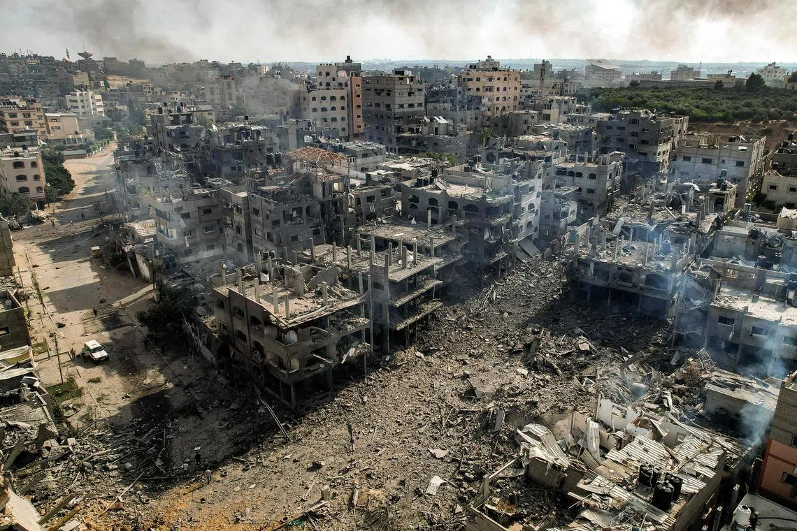 Buildings destroyed by Israeli air strikes in the Jabalia camp for Palestinian refugees in Gaza City on Oct 11.