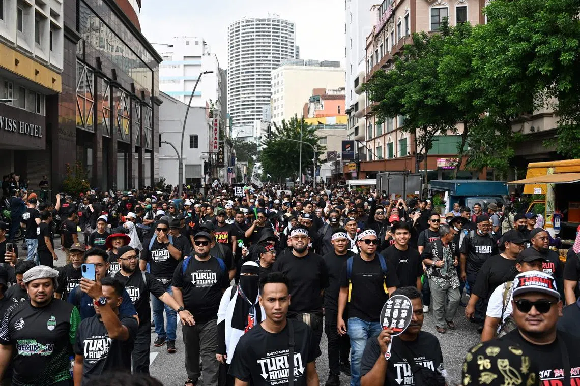 Protesters marching towards Merdeka Square during a protest against Prime Minister Anwar Ibrahim in Kuala Lumpur on July 26.