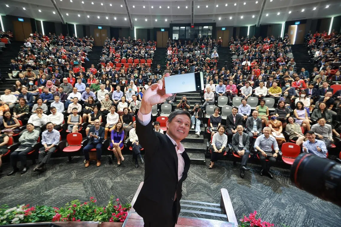 Education Minister Chan Chun Sing taking a wefie with participants at the Pre-University Seminar 2023 at the Lee Kong Chian Lecture Theatre at the Nanyang Technological University on May 29. ST PHOTO: KEVIN LIM 