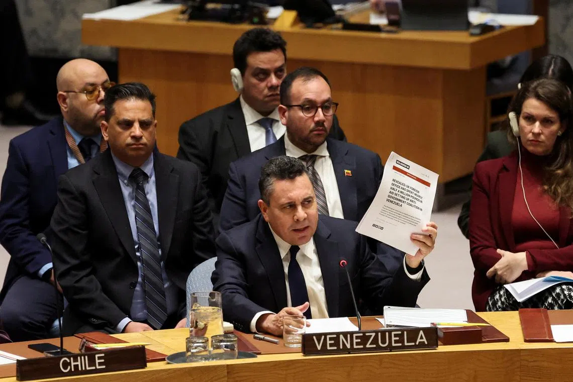 Venezuela Ambassador to the United Nations Samuel Reinaldo Moncada Acosta speaks as he holds up a news article, during a UN Security Council meeting on U.S. strikes and the capture of Venezuelan President Nicolas Maduro and his wife, Cilia Flores, at the United Nations headquarters in New York, U.S., January 5, 2026. REUTERS/Brendan McDermid