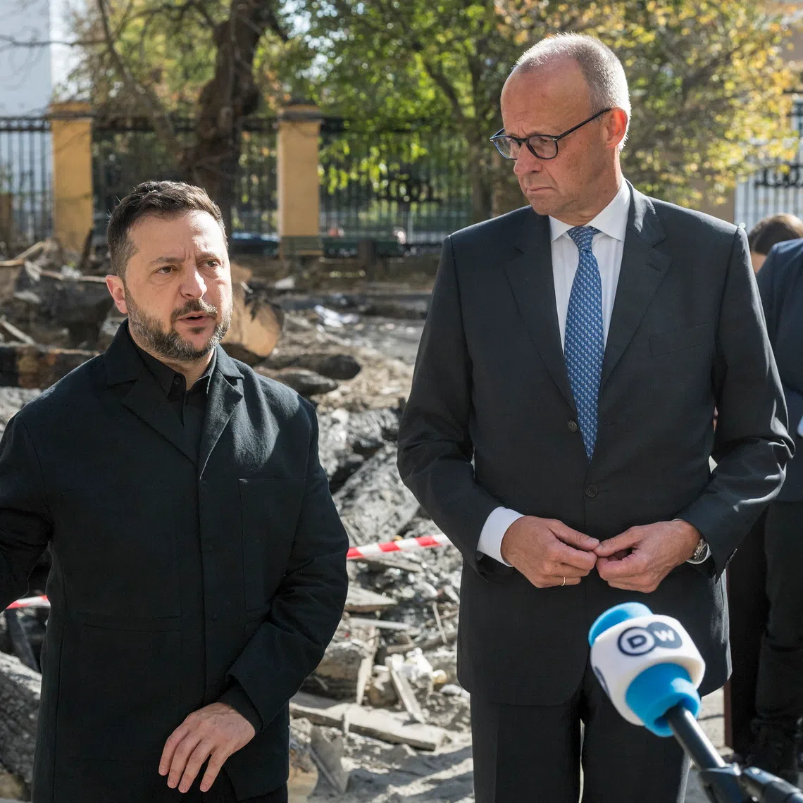 Germany’s Chancellor Friedrich Merz (right) and Ukraine’s President Volodymyr Zelensky attend the site of a Russian strike on the building of the National Academy of Sciences in Kyiv, Ukraine, on Oct 4.