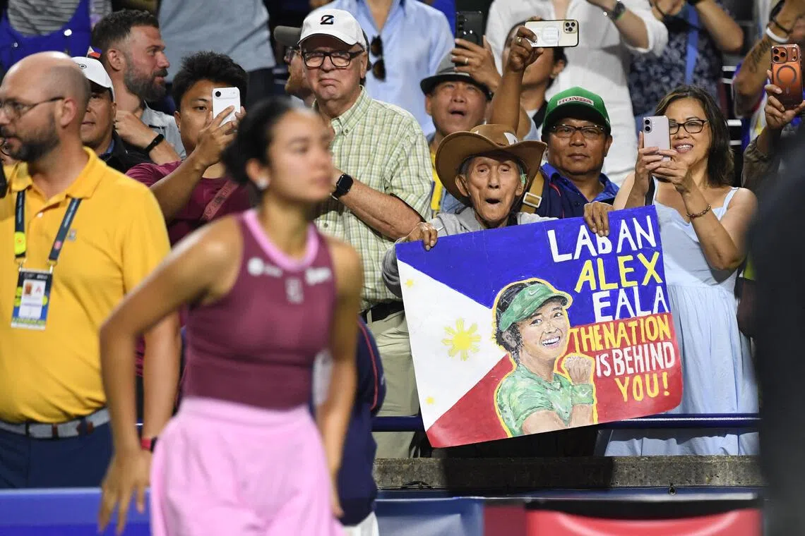A Filipino fan hoists a sign that says, “Laban (fight), Alex Eala. The nation is behind you” during third round play at the Canadian Open in August.