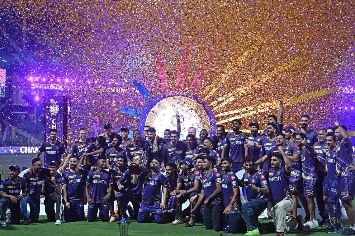 Kolkata Knight Riders players and team members with the trophy after winning the Indian Premier League (IPL) Twenty20 final against Sunrisers Hyderabad at the MA Chidambaram Stadium in Chennai on May 26, 2024.