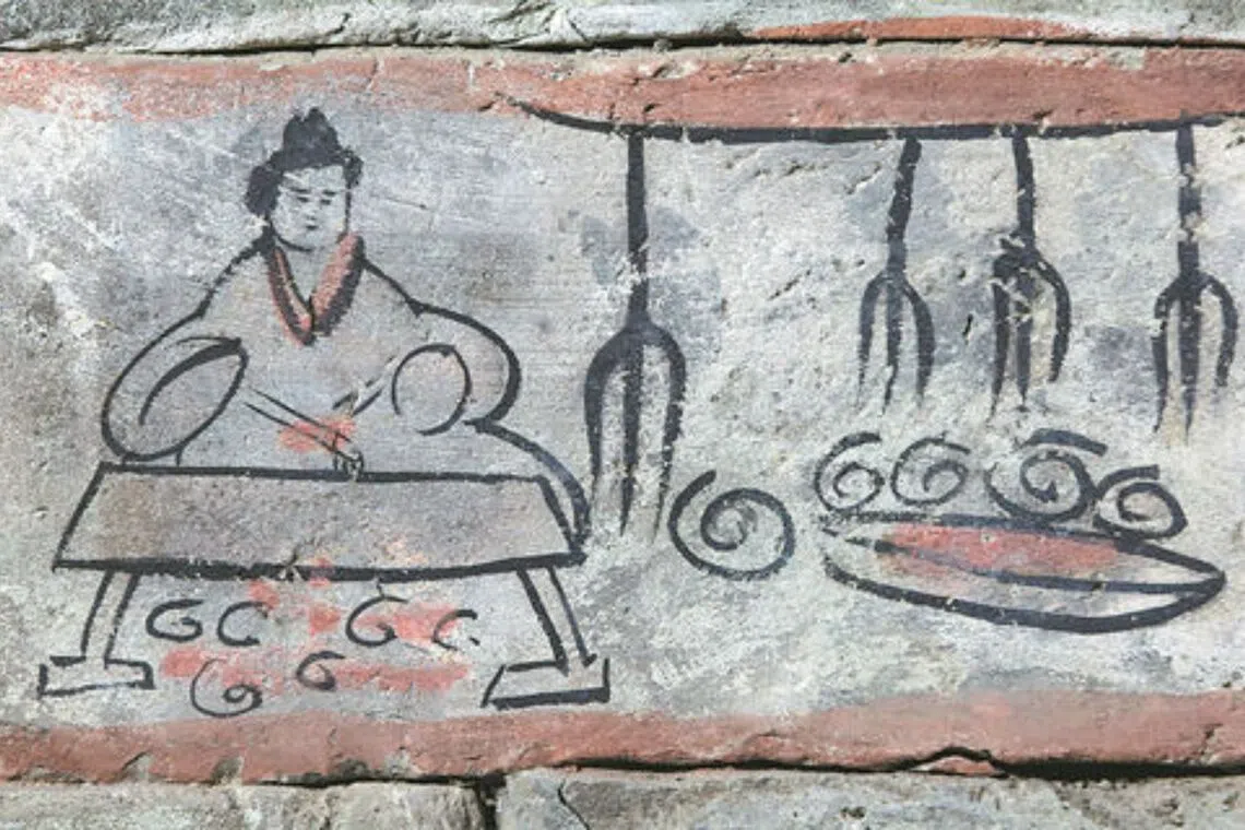 A mural brick found in the Wei and Jin Dynasty Tombs in Jiayuguan, Gansu province, depicts a chef roasting meat on fire before serving it to guests at a banquet.