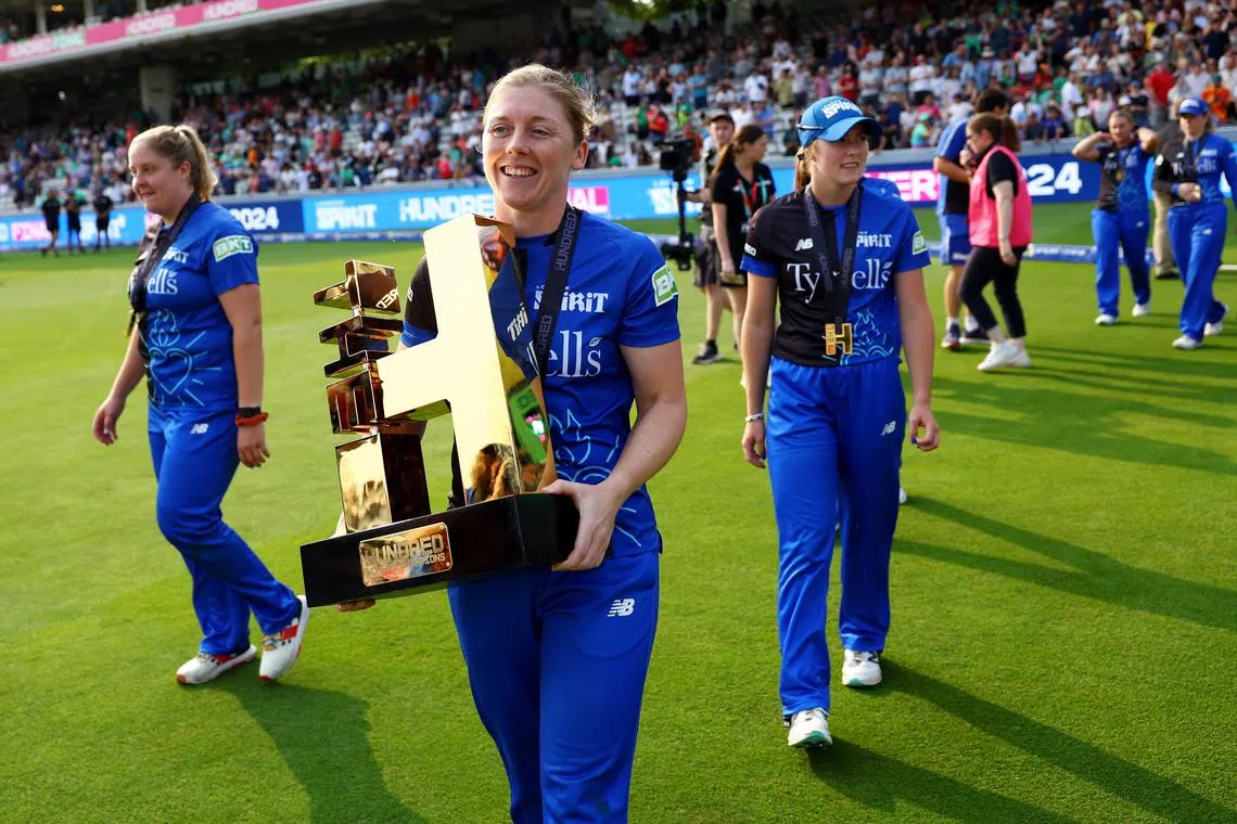 London Spirit's Heather Knight celebrates with the trophy after winning the Women's Hundred final.