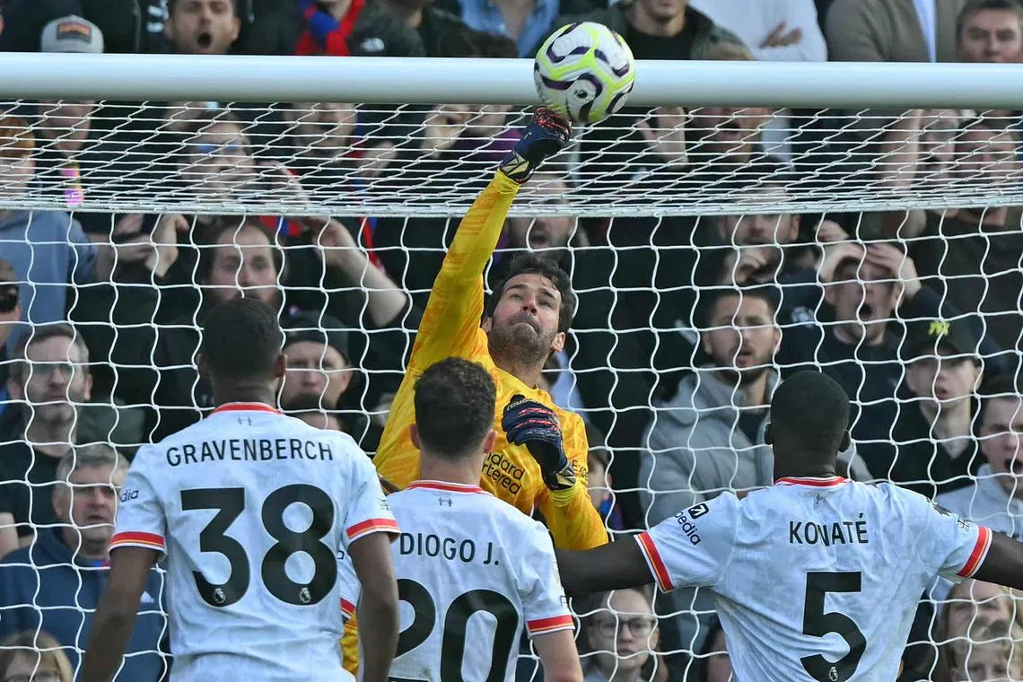 Liverpool's Brazilian goalkeeper Alisson Becker makes a save during the match against Crystal Palace.