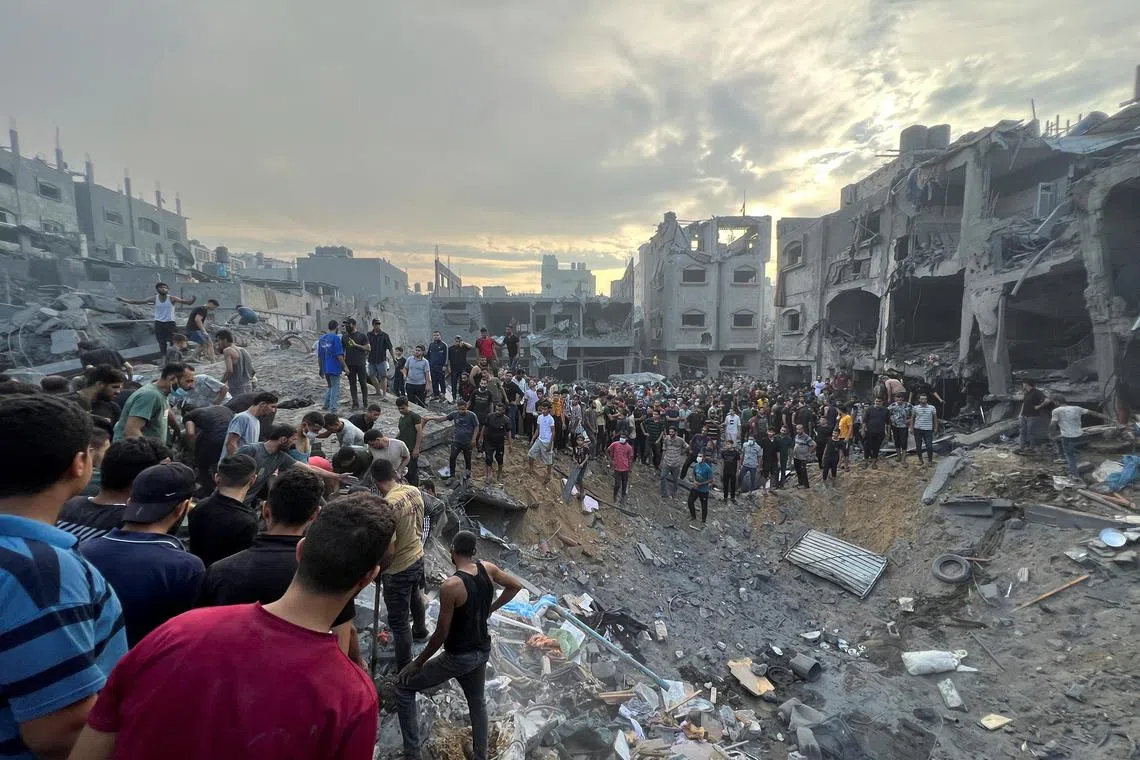 Palestinians search for casualties at the site of Israeli strikes on houses in Jabalia refugee camp in the northern Gaza Strip, on Oct 31.