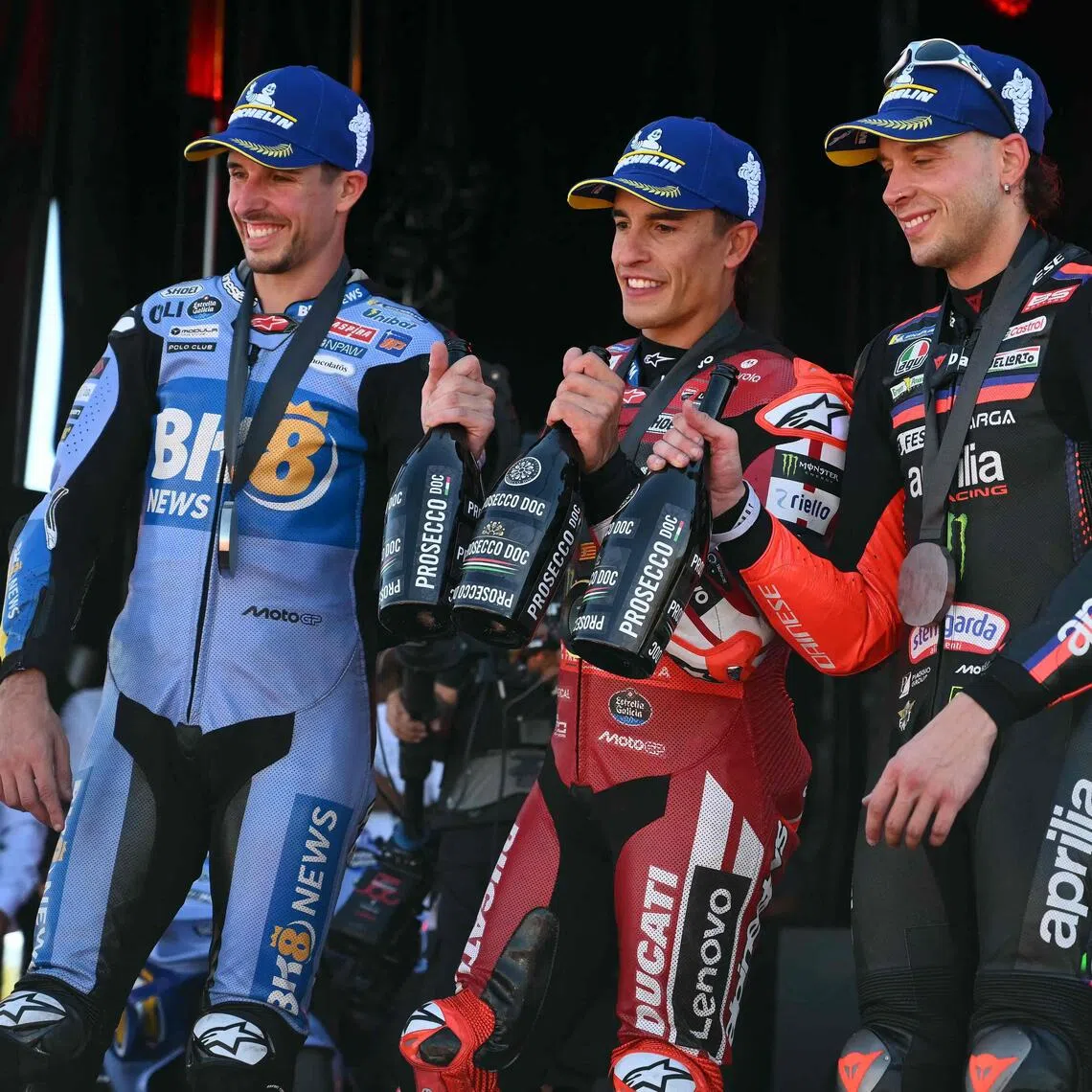Winner Team Ducati Lenovo Team's Marc Marquez (C) celebrates on the podium with second placed Team Gresini Racing MotoGP's Alex Marquez (L) and third placed Team Aprilia Racing's Marco Bezzecchi after the sprint race of the MotoGP Aragon Grand Prix at the Motorland circuit in Alcaniz, northeastern Spain, on August 29, 2026. (Photo by JOSE JORDAN / AFP)