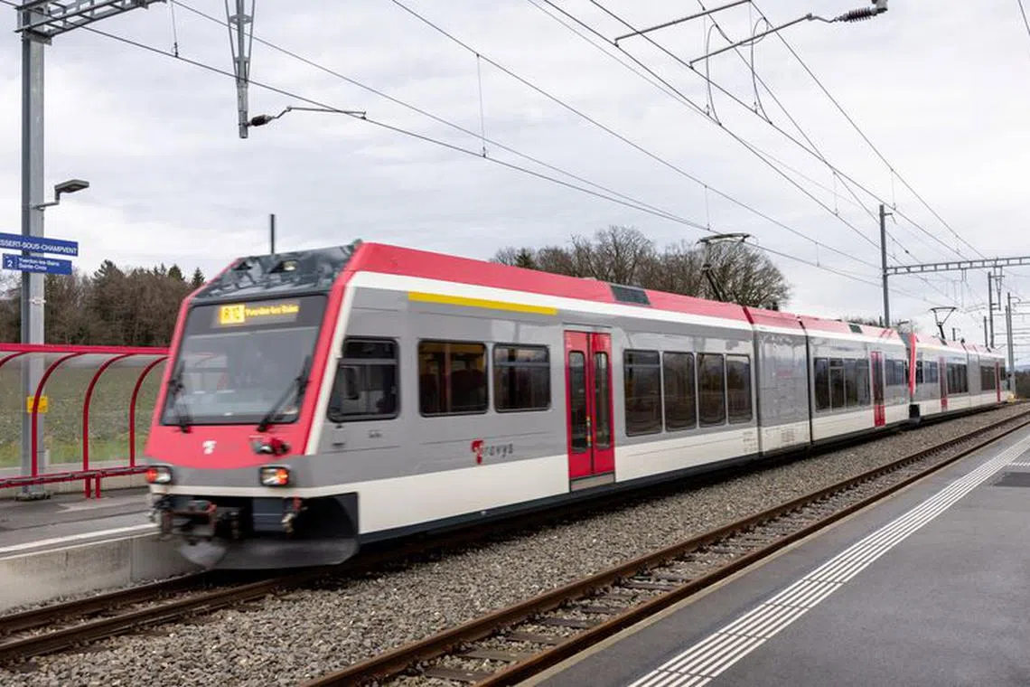 A train passes through the station close to where a man armed with an axe and a knife held 15 hostages on a train for almost four hours until police stormed the train and fatally wounded him on February 8, in Essert-sous-Champvent near Yverdon-les-Bains, Switzerland, February 9, 2024. REUTERS/Denis Balibouse