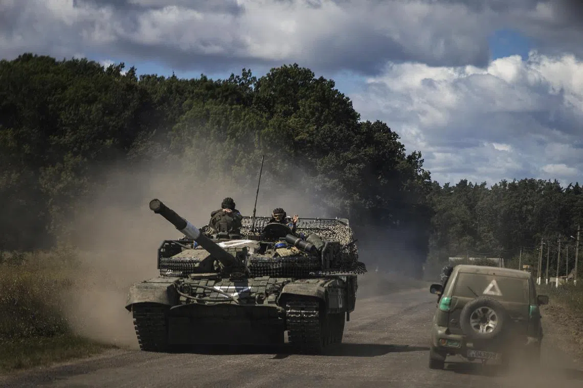 Ukrainian soldiers in a tank near Sumy, Ukraine, driving on the main road near the Russian border towards the Kursk region, in August 2024. 