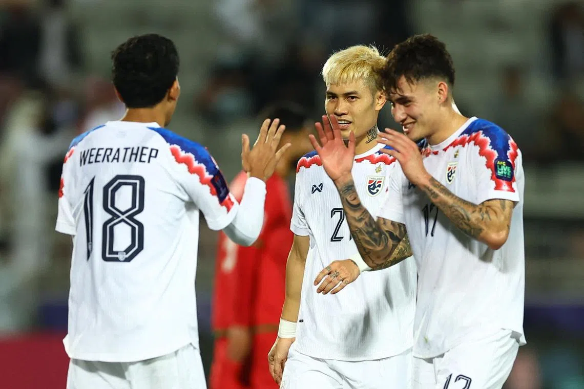 Thailand's Nicholas Mickelson, Weerathep Pomphun and Suphanan Bureerat react after the match.