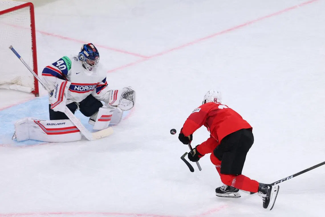 Ice Hockey - IIHF World Championships - Semi Final - Switzerland v Norway - Swiss Life Arena, Zurich, Switzerland - May 30, 2026 Switzerland's Denis Malgin shoots at goal REUTERS/Denis Balibouse