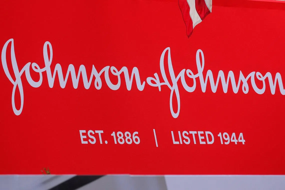 FILE PHOTO: The company logo for Johnson & Johnson is displayed to celebrate the 75th anniversary of the company's listing at the New York Stock Exchange (NYSE) in New York, U.S., September 17, 2019. REUTERS/Brendan McDermid/File Photo