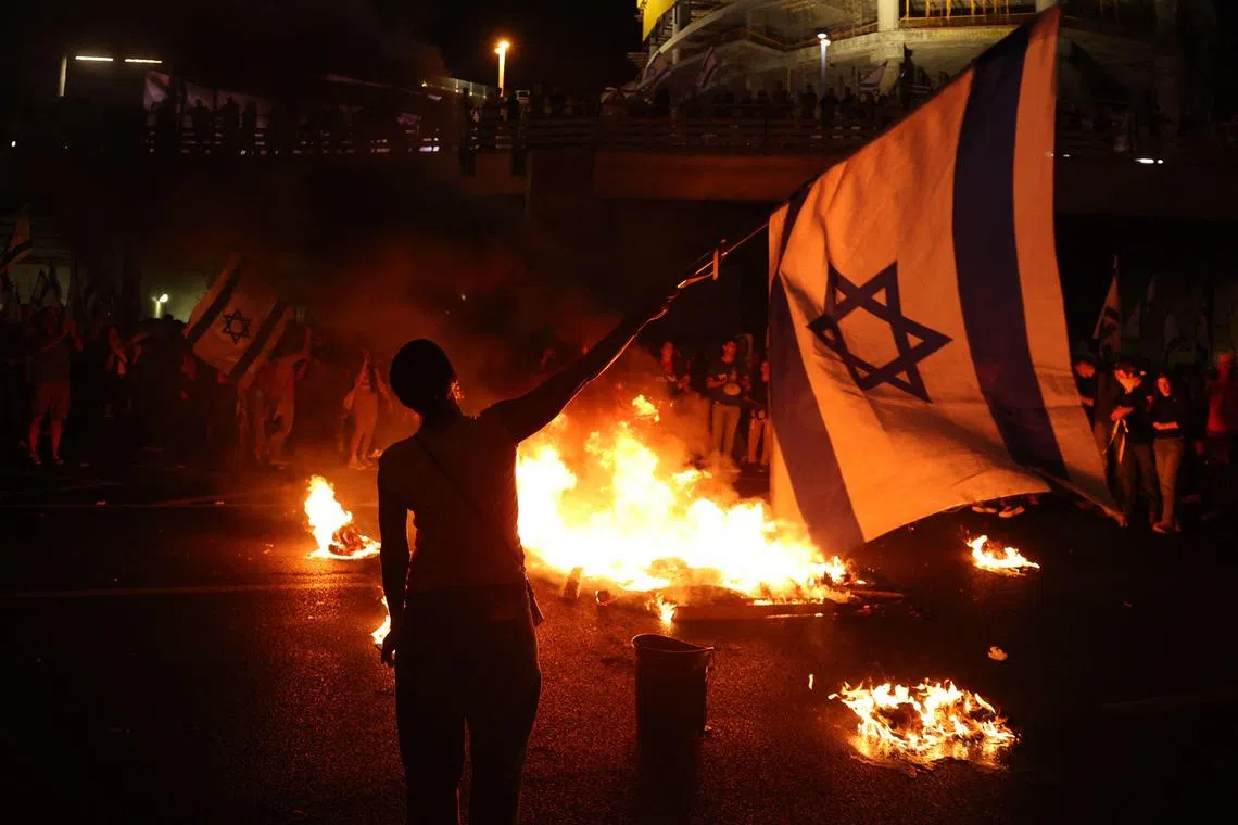 Protesters blocking a road in Tel Aviv on Nov 5 after the dismissal of Israel's defence minister Yoav Gallant.