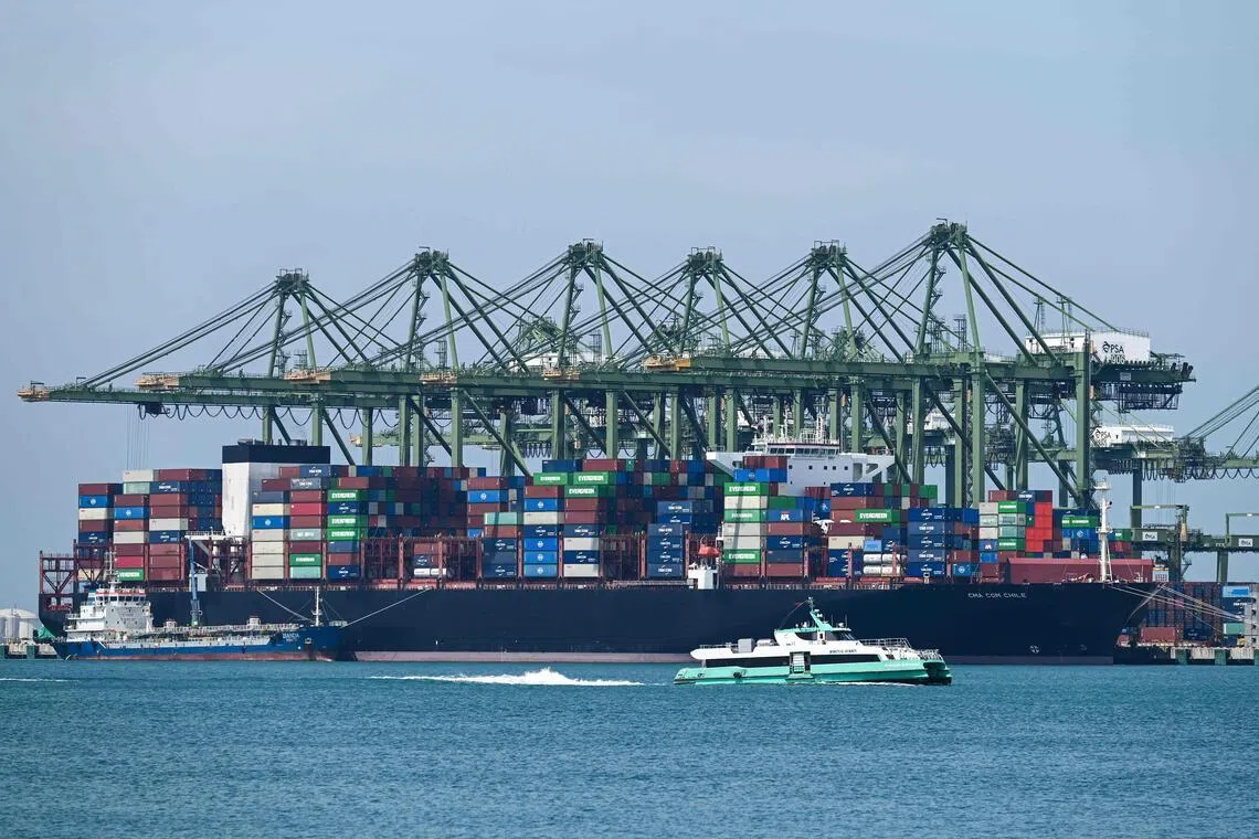 An oil tanker (L) refuels a container vessel docked at Pasir Panjang port terminal in Singapore on March 10, 2026. (Photo by Roslan RAHMAN / AFP)