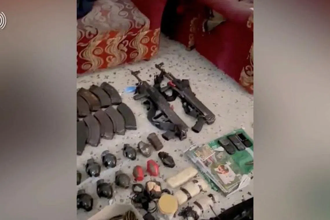 View of what Israeli army says are weapons seized from an area around Kamal Adwan hospital in a location given as Beit Lahia, Gaza, as seen in this screen grab taken from a handout video released December 16, 2023. Israeli Army/Handout via REUTERS