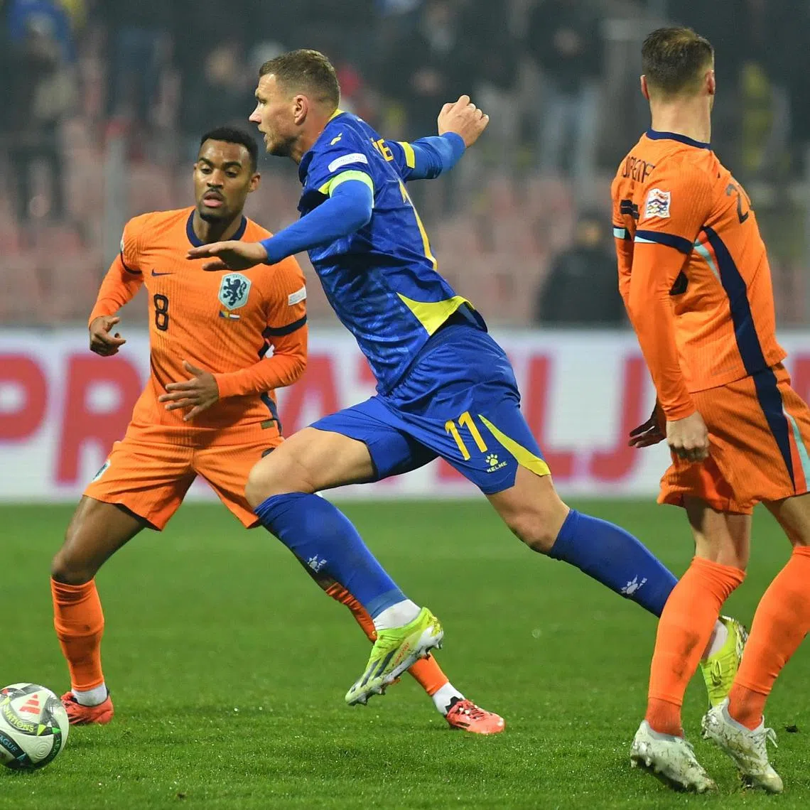 Bosnia and Herzegovina captain Edin Dzeko (centre) in action against Netherlands midfielder Ryan Gravenberch (left) during the Nations League match that ended 1-1 in Zenica, Bosnia and Herzegovina, on Nov 19. It was Dzeko's final international appearance.