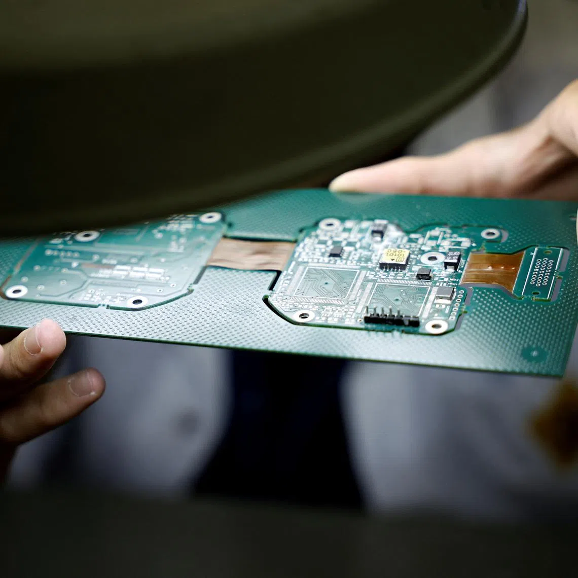 An employee inspects a panel of printed circuit boards (PCBs) at the Hellenic Aerospace Industry (HAI), in Tanagra, north of Athens, Greece, July 3, 2025. REUTERS/Louiza Vradi