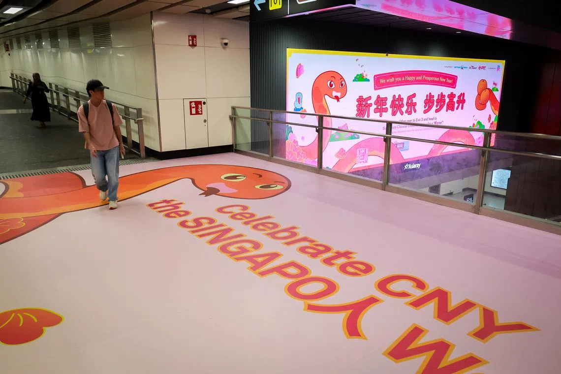 A Chinese New Year-themed floor mural and LED display at Shenton Way MRT station.