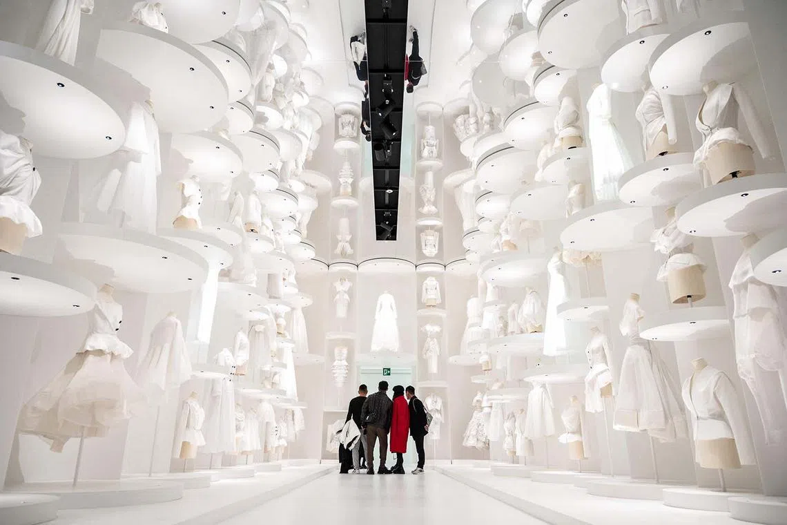 TOPSHOT - In this picture taken on December 19, 2022, guests visit the exhibition "Christian Dior: Designer of Dreams" during a media preview at the Museum of Contemporary Art Tokyo in Tokyo. (Photo by Yuichi YAMAZAKI / AFP)