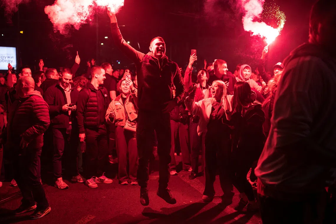 Image 3: Supporters of the electoral list "Student List - Students Win" celebrate after Aleksandar Vucic, Serbian Progressive Party (SNS) prime ministerial candidate, conceded defeat in the parliamentary election in Belgrade, Serbia, October 25, 2026. REUTERS/Marko Djurica