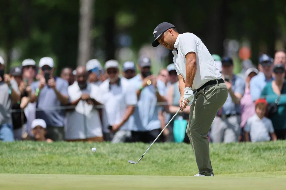 Xander Schauffele, of the US, chips on the first green during the third round of the PGA Championship.